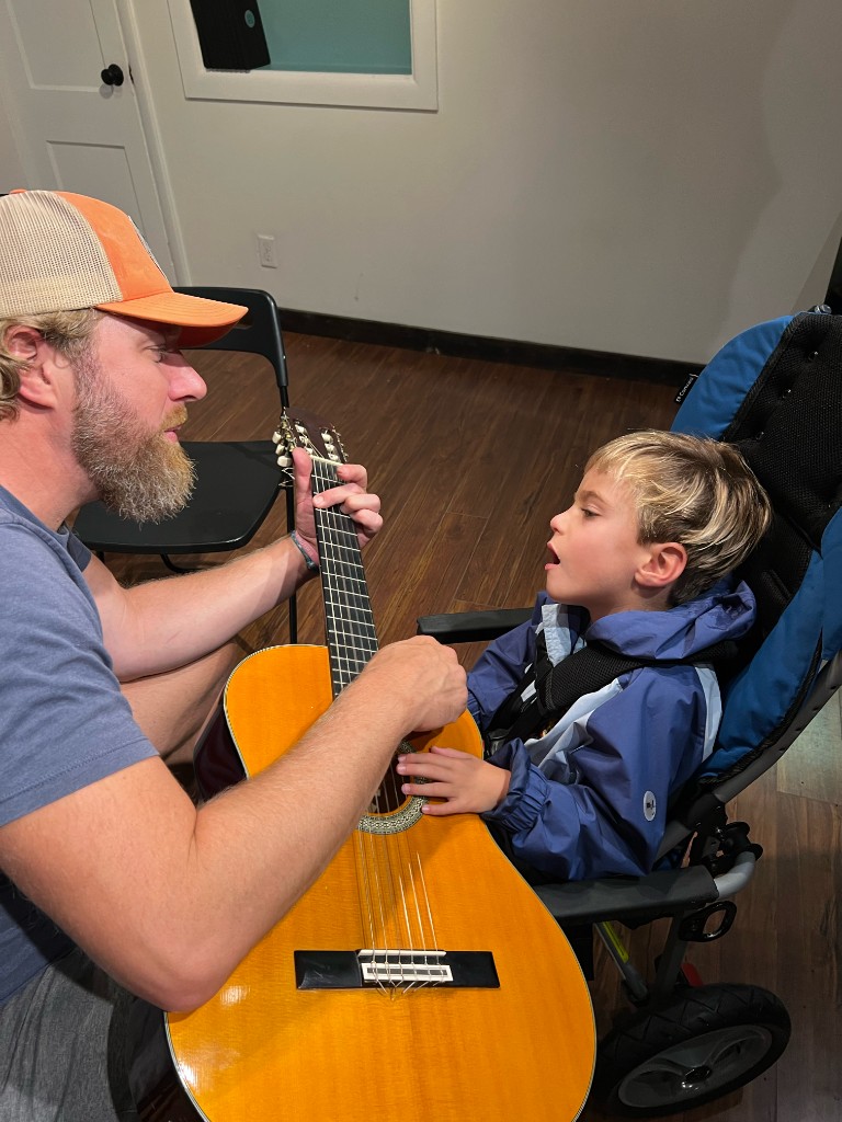 One-on-one guitar moment with a student
