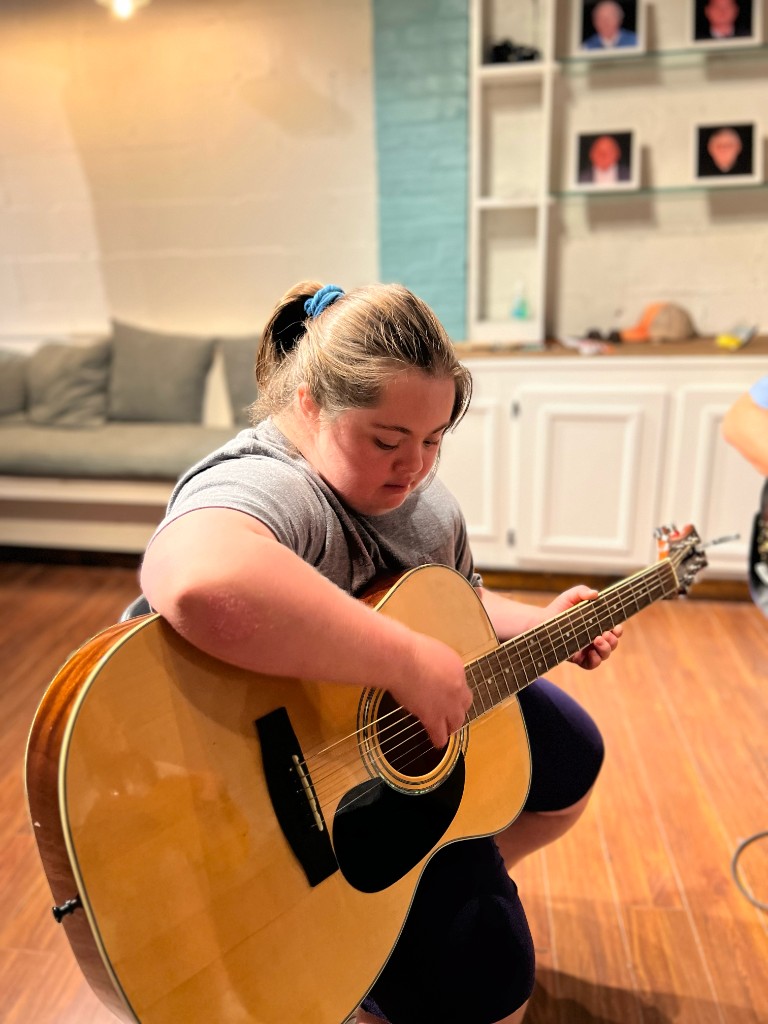 Shared guitar moment during a lesson