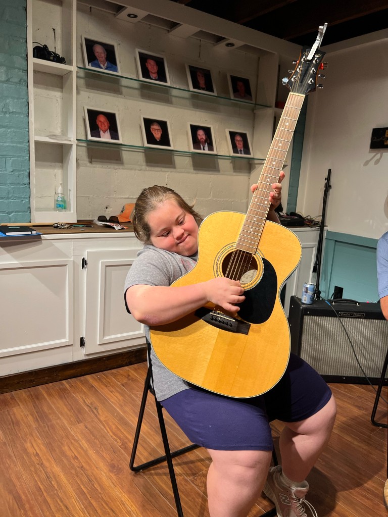 Young musician with ukulele and electronic drums